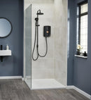 Modern shower setup with tiled walls and a glass enclosure in a bathroom.