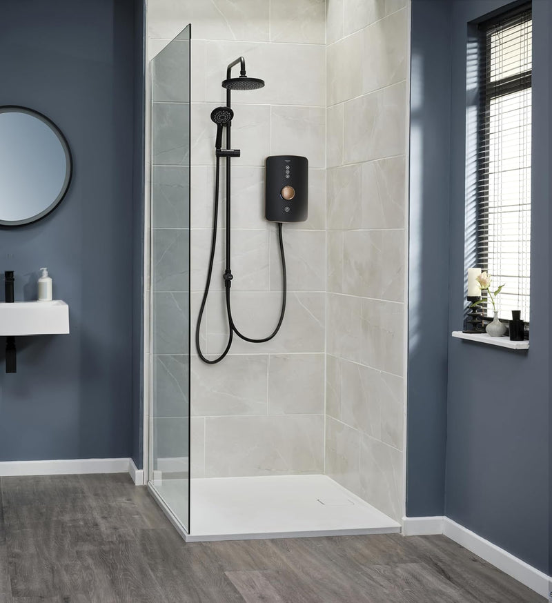 Modern shower setup with tiled walls and a glass enclosure in a bathroom.